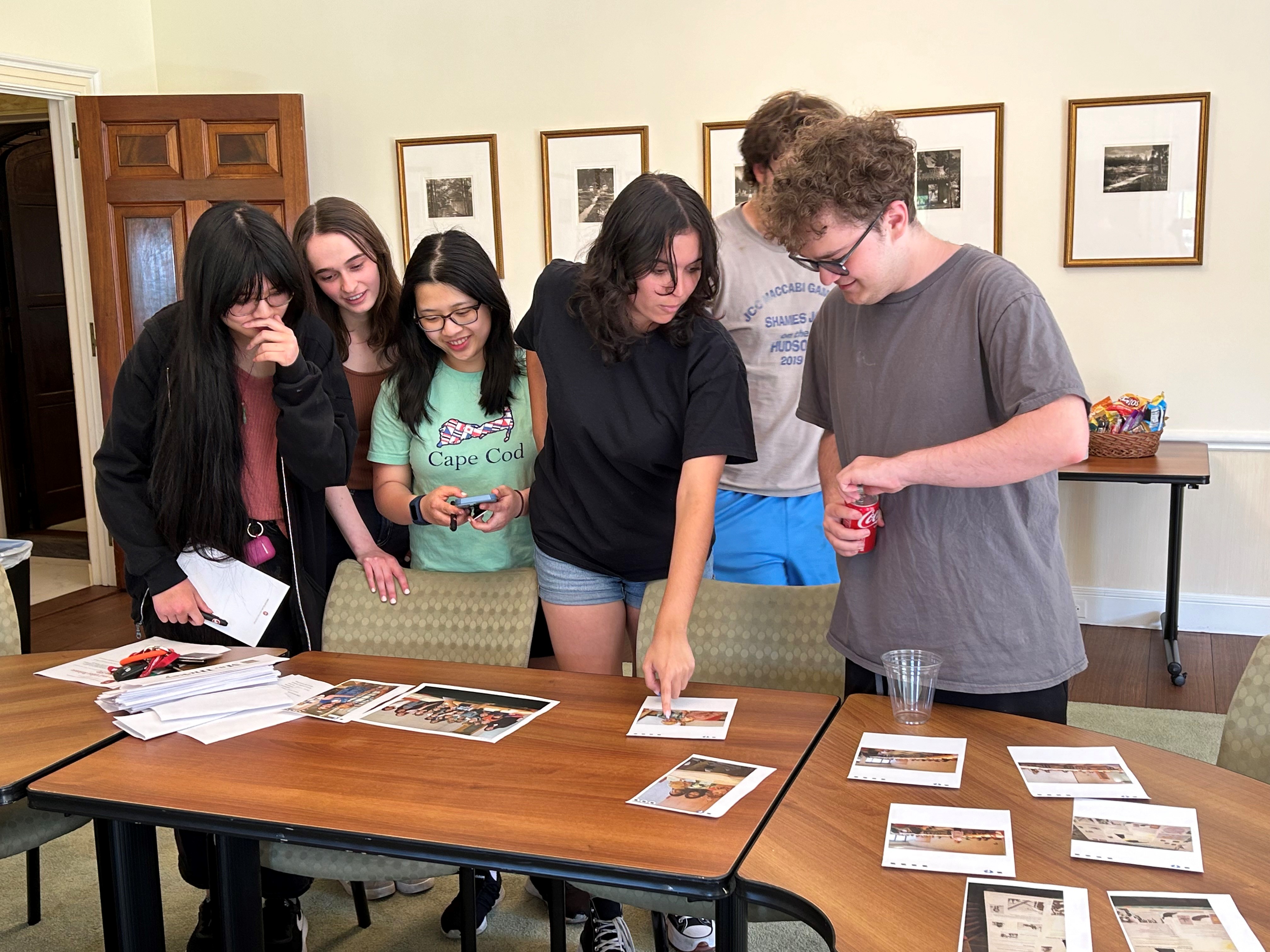 students looking at photos from when they were part of the 5th grade archive project in 2017