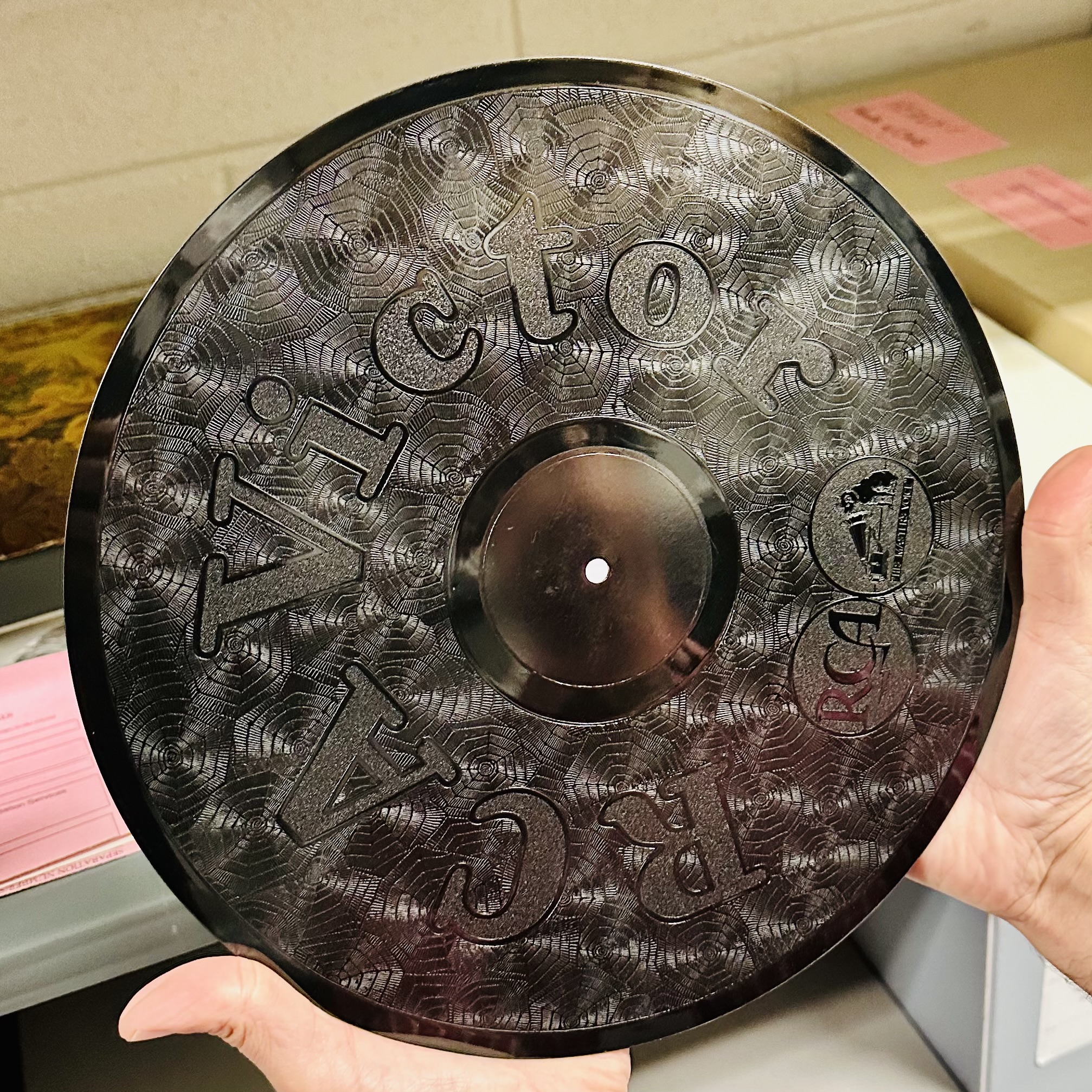 Inspecting unique, custom-made phonograph records belonging to the Rockefeller family.