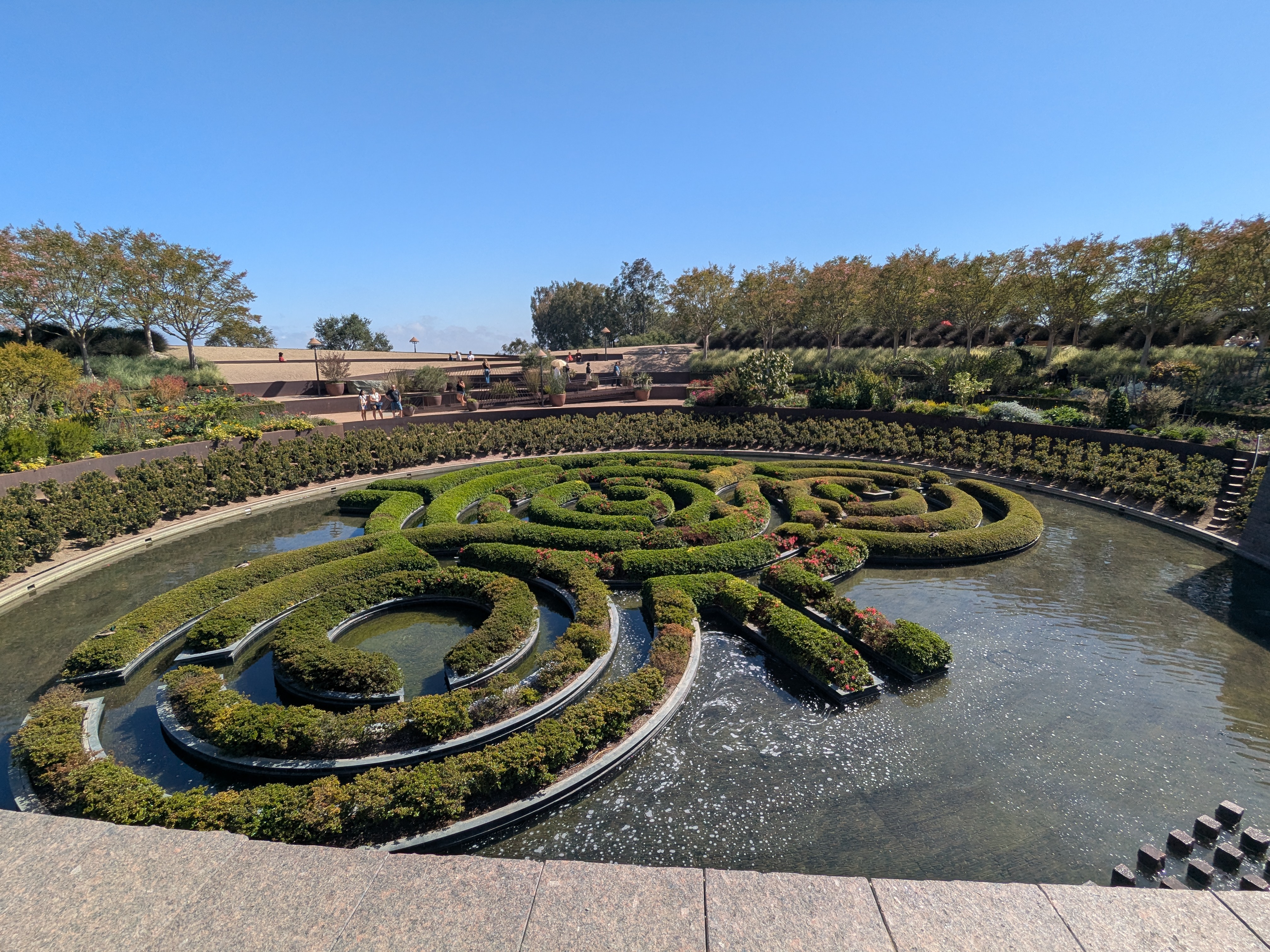 The Getty Gardens in bloom, featuring a shrub labyrinth sitting on top of a pond